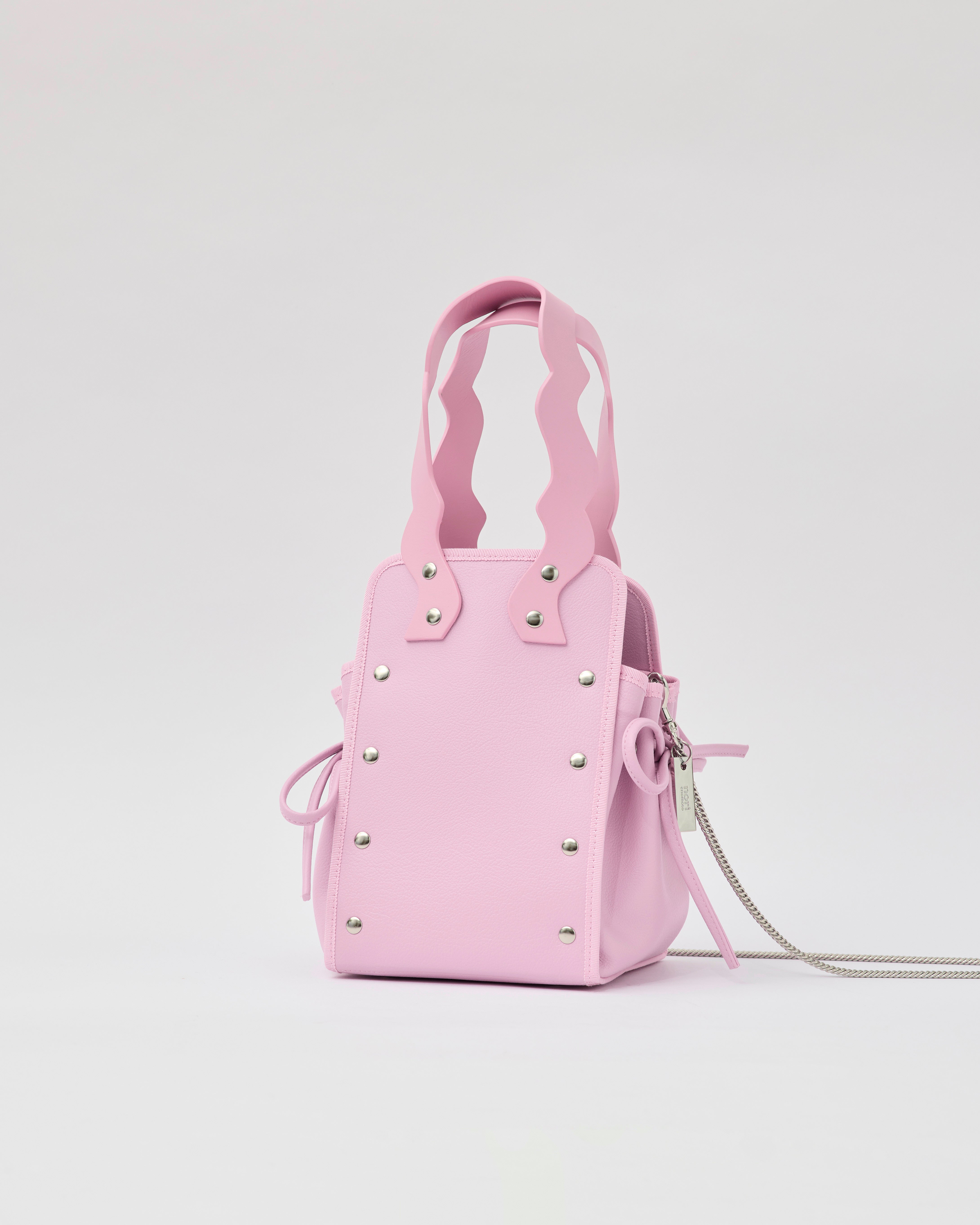 本革ハンドルの巾着型ハンドバッグ。サイドのドローストリングでシルエットを変化可能。500mlペットボトル対応サイズで内ポケット付き。取り外し可能なチェーンストラップでショルダー・クロスボディ両用。