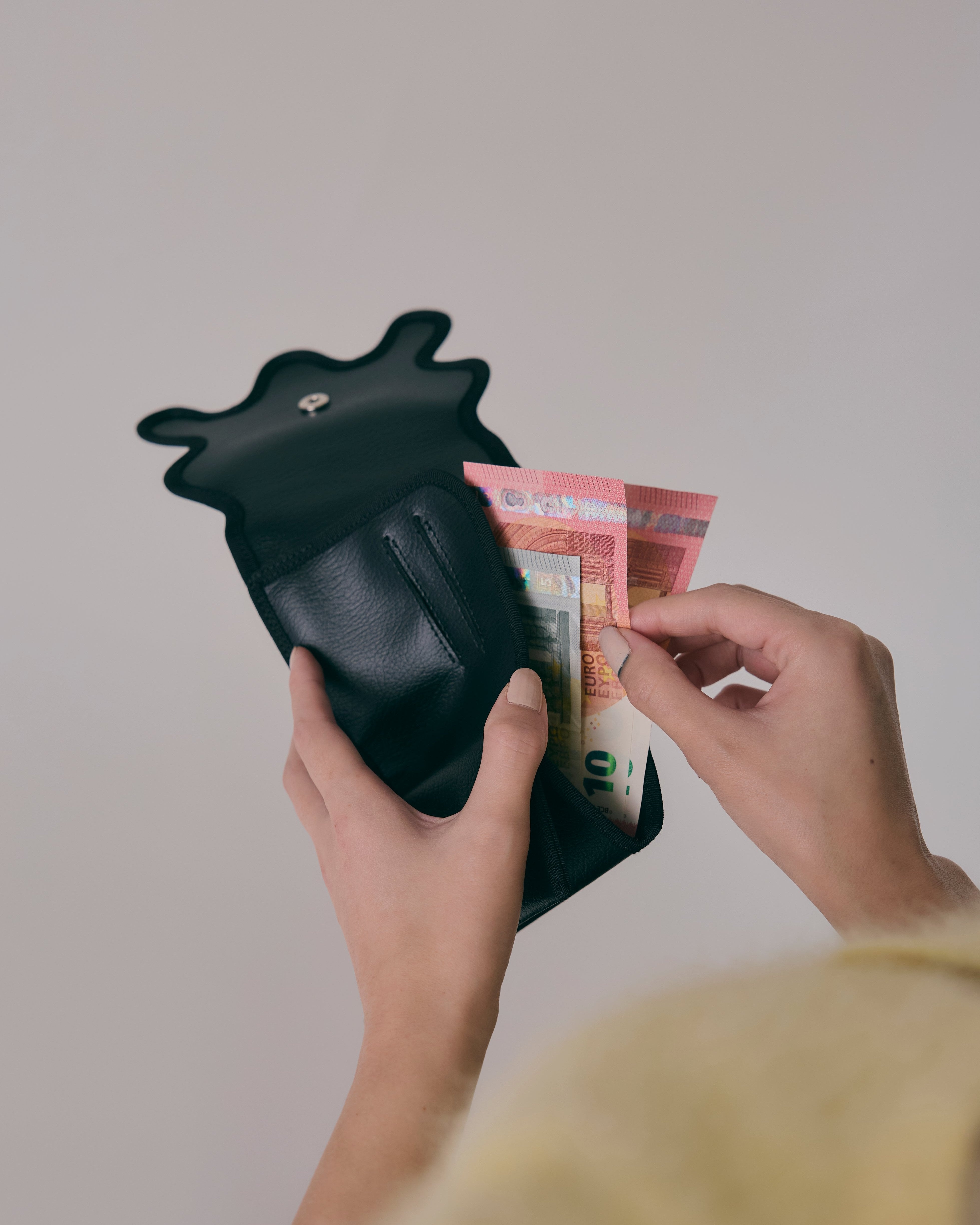 nori enomoto　wave mini wallet　表面にエンボスロゴを施した三つ折り仕様のウォレット。小銭入れ、紙幣ポケット、カードスリットを備えた多機能コンパクト財布。